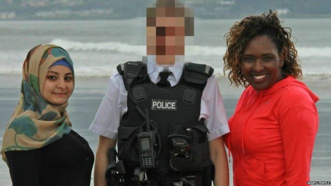 A PSNI officer accompanies Syrian refugee Bayan Khelo (left) and Lilian Seenoi ofThe North West Migrants Forum